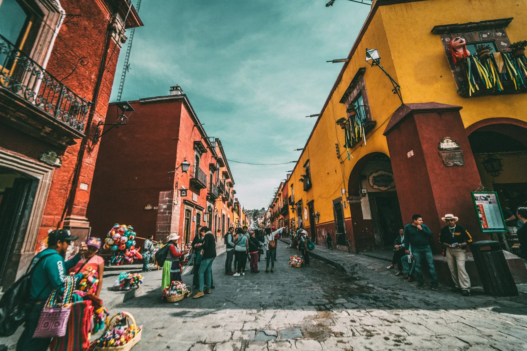 A colourful colonial street in Mexico, with painted facades and stone paving